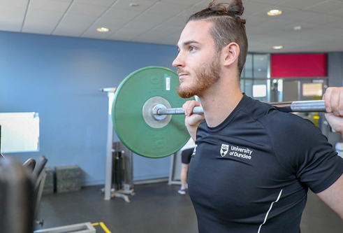 A gymgoer lifting weights at the Strength Performance Centre