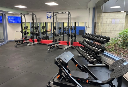 Free weights and weight machines in the personal training suite.