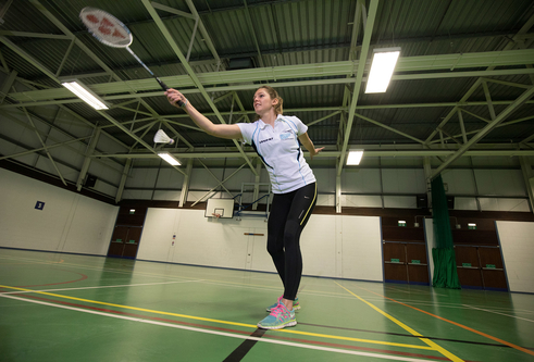 Girl playing badminton in Sports Hall