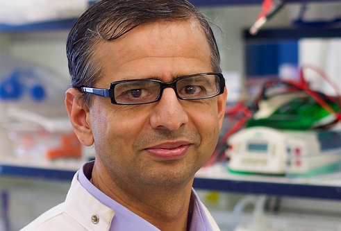 Profile photograph of Professor Gopal Sapkota wearing a lab coat in a lab setting