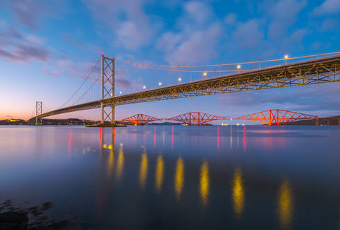 The Forth Road bridge and rail bridge at Edinburgh during sunset