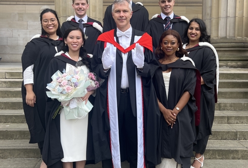 Dean of Dentistry, Professor Philip Preshaw, is presented with the white gloves by some of this year's cohort of graduates.