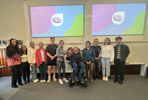 Students from the University of Dundee, stand in a line and collect a wooden shield, as recognition of their success in the Dental Public Health project.