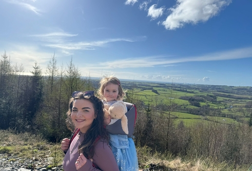 Nicole Hindley walking in the countryside with Skye on her back