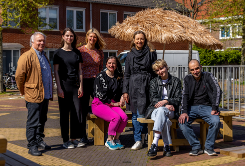 Members of the Urban ReLeaf team stand lined up, smiling