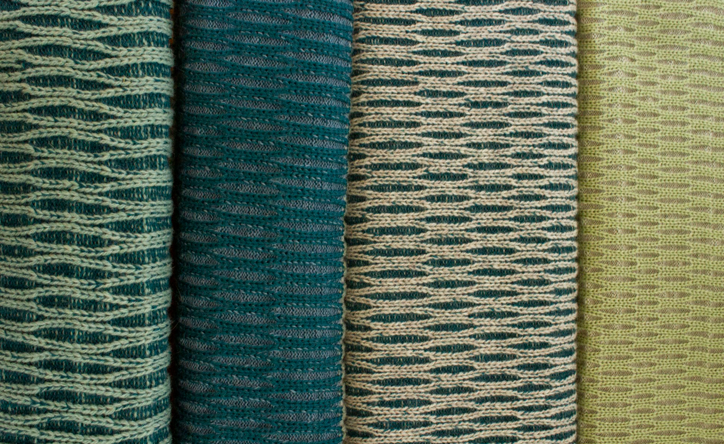 The image shows a closeup of four different patterned samples of knitted fabric, in blue and green tones.